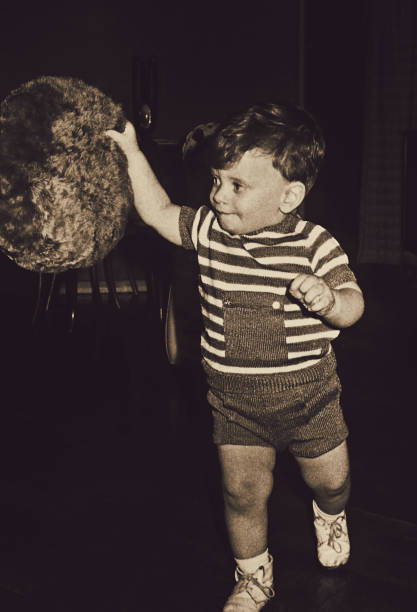 istock Sepia vintage boy playing at home 870195494