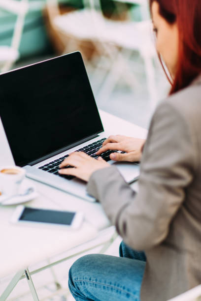 Technology Back view of young woman at cafe working on laptop and drinking coffee 3686 stock pictures, royalty-free photos & images