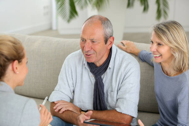 istock agent explaning contract to senior couple 870198798