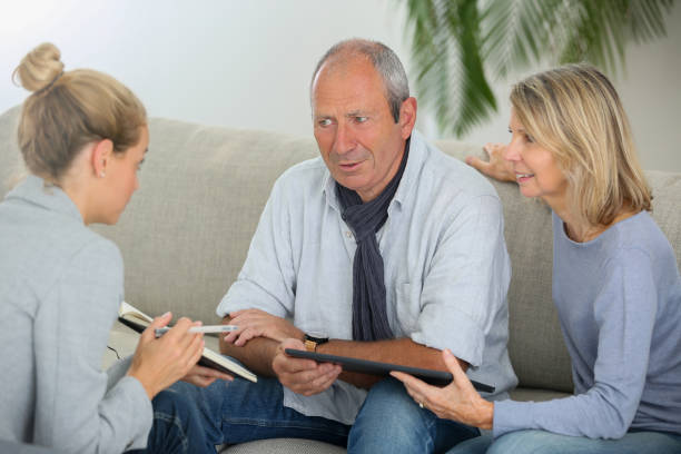 istock agent explaning contract to senior couple 870198816