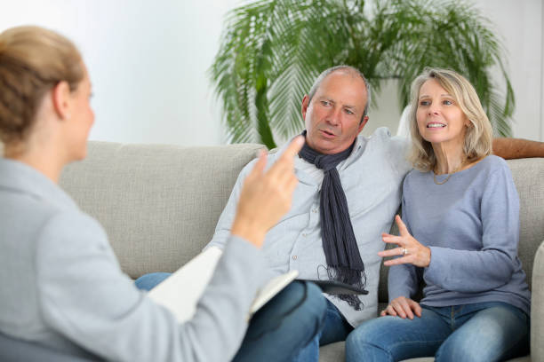 istock insurance agent talking to senior couple 870198940