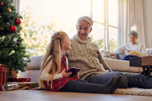 istock Senior man and granddaughter with digital tablet at home 870199080