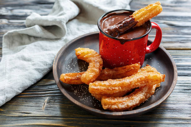 istock Churros with sugar and cinnamon and hot chocolate. 870199912