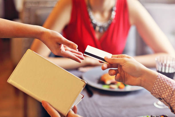 istock People paying in restaurant by credit card reader 870200898