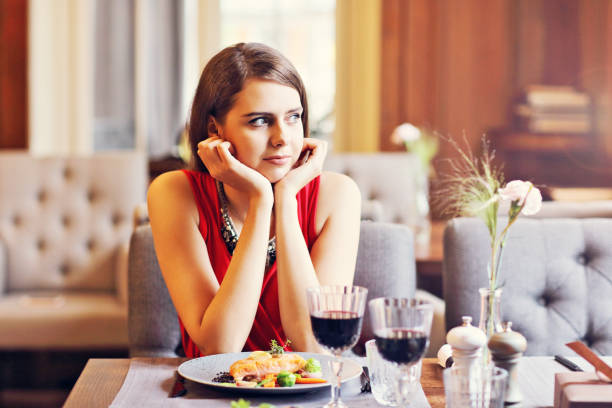 istock Bored Woman Alone at Restaurant 870203122