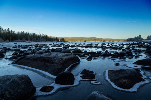 istock Stones in the frozen river 870203612