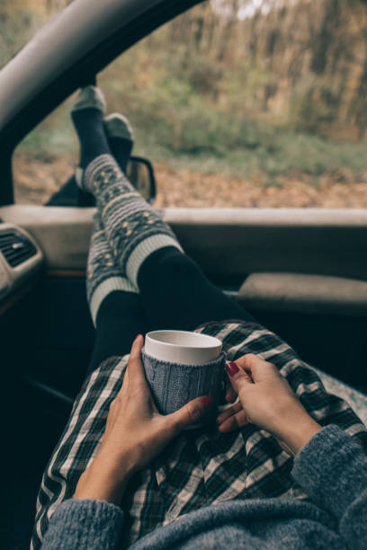 istock Woman relaxing in car interior with a mug 870204110