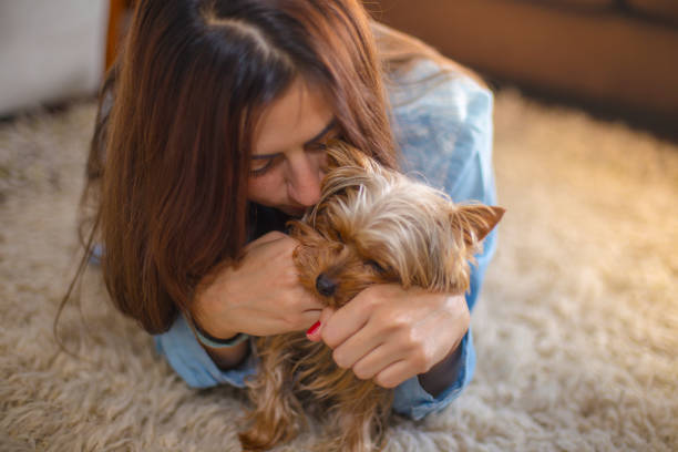 istock Young woman stroking her dog 870204206