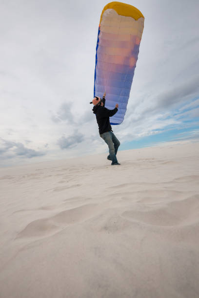istock Adventurer, in a funny hat, training with a kite 870210846