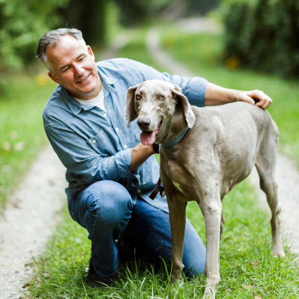 istock Mature man with his dog. 870219566