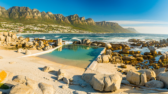 Camps Bay ocean pool with Twelve Apostles behind