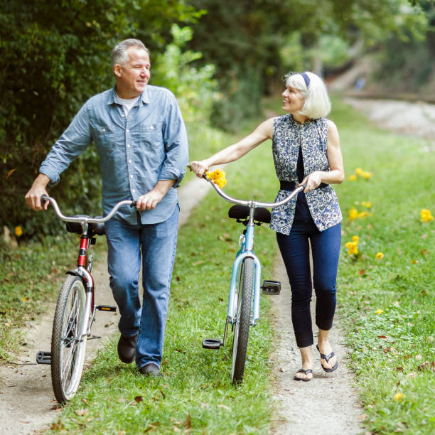 istock Mature couple riding bicycle on dirt road. 870226172