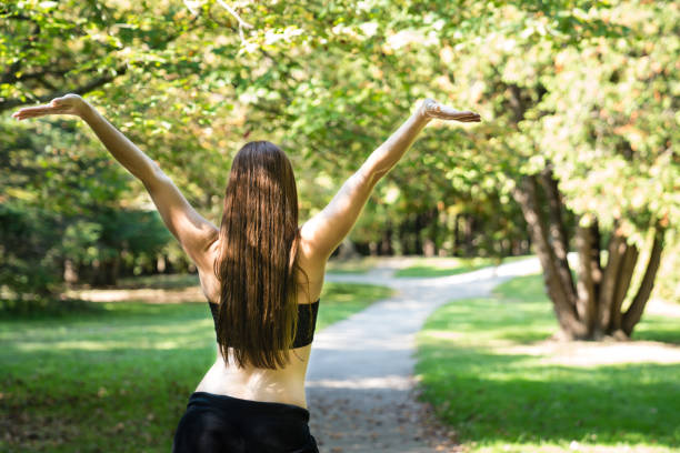 istock Freedom looking down a path from the back of a beautiful confident young woman 870227356