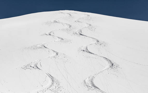 pistes de ski dans la pente de la montagne - ski track powder snow track snow photos et images de collection