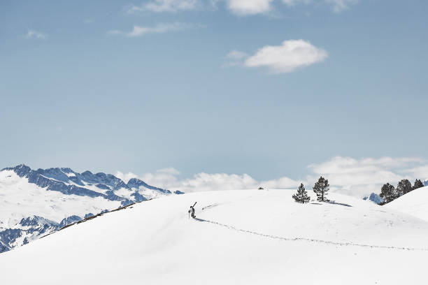 Mount Etna rising majestically with its snowy peak above the Sicilian landscape, surrounded by a dramatic, cloud-filled sky