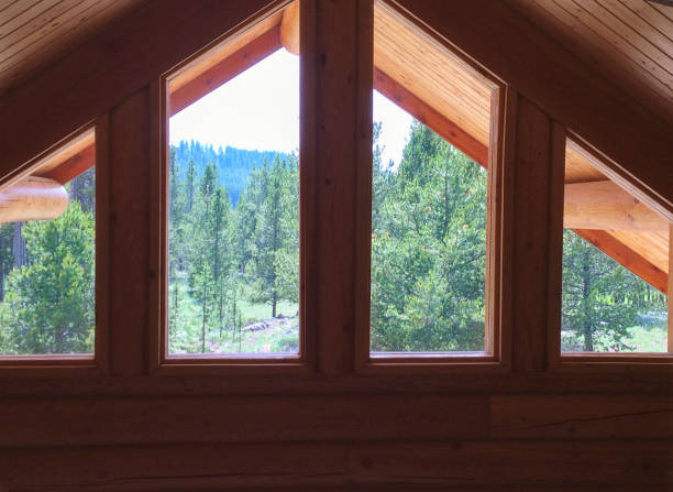 istock A-Frame Log Cabin With Large Windows Overlooking A Mountain Range of Pine Trees 870236714