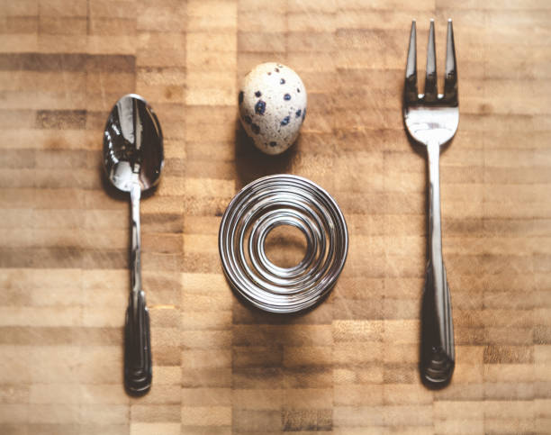 Egg quail, helical rack and equipment on board Egg quail, spiral stand, fork, spoon lie on the board. Set for dietary breakfast helical stock pictures, royalty-free photos & images