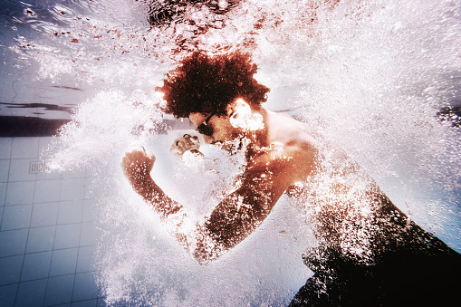 Young man training martial arts underwater