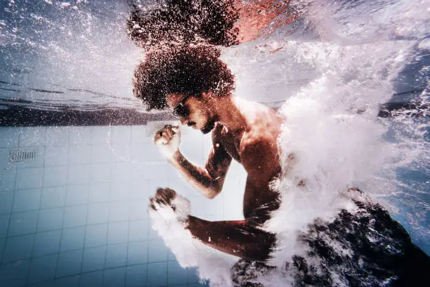 Photo of Young man training martial arts underwater