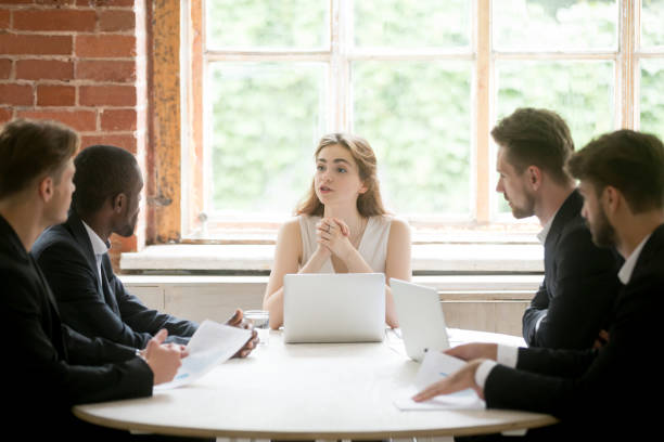 istock Female executive coaching group of corporate employees during briefing. 870244248