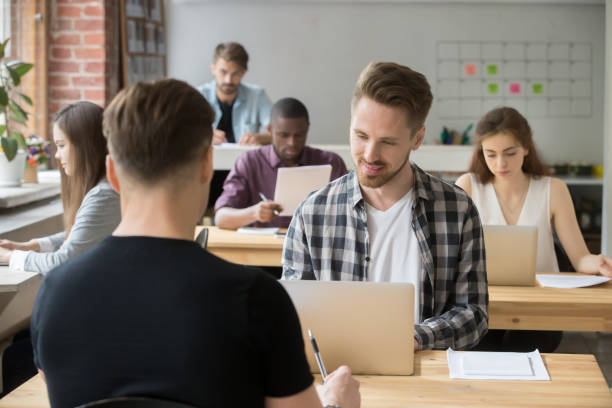 istock Young casually dressed employees at work in shared coworking office. 870244284