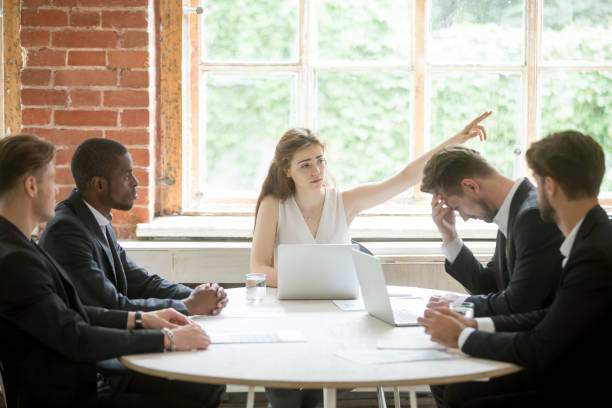istock Strict boss telling upset employee to leave room during briefing. 870244292