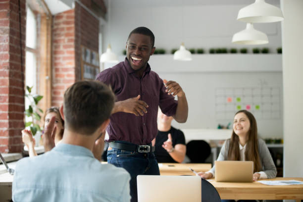 istock African american office worker  dancing surrounded by colleagues. 870244362