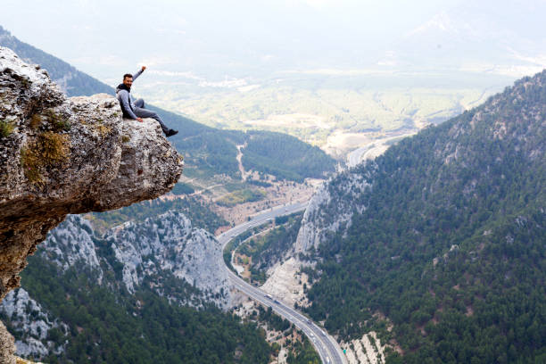 istock Mountain Man Success Concept on high Rock 870251186