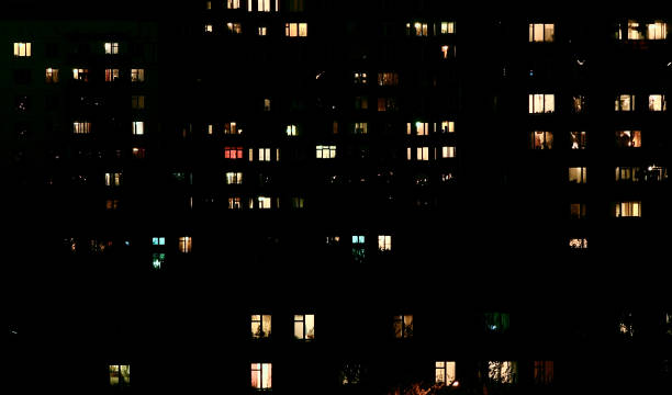 istock Illuminated widows in residential building in Moscow by evening. 870255238