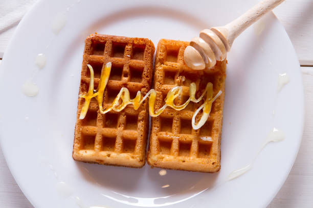 istock Pouring honey on waffles 870274276