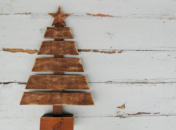 istock Vintage wooden Christmas tree on old rustic white background. 870277452