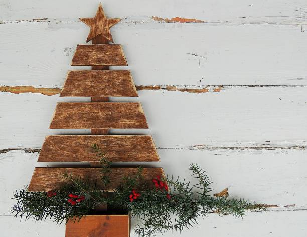 istock Vintage wooden Christmas tree on old rustic white background. 870277476
