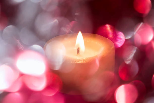 istock festive background with colored blurry light circles and a hot candle 870284182