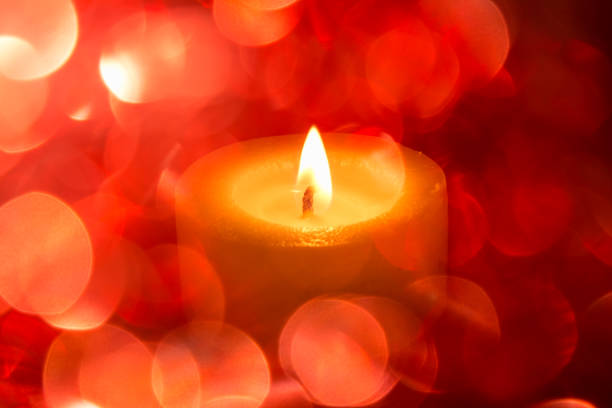 istock festive background with colored blurry light circles and a hot candle 870284192
