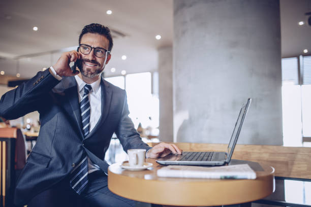 istock Businessman talking on phone in cafe 870287268