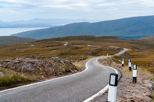 A narrow single-track road in the remote Western Highlands - Scotland, UK