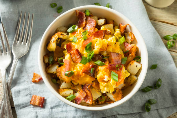 Homemade Egg and Potato Breakfast Bowl Homemade Egg and Potato Breakfast Bowl with Bacon hash brown stock pictures, royalty-free photos & images