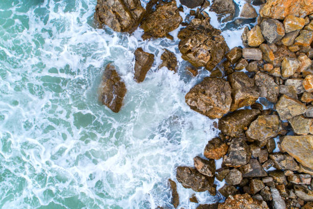 istock Flight over the turquoise waves that beat the rocks in Montenegro 870330890
