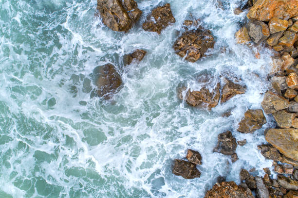 istock Flight over the turquoise waves that beat the rocks in Montenegro 870330932