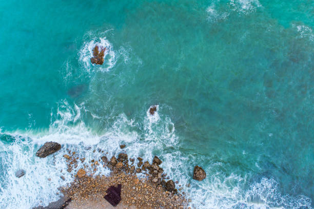 istock Flight over the turquoise waves that beat the rocks in Montenegro 870332204