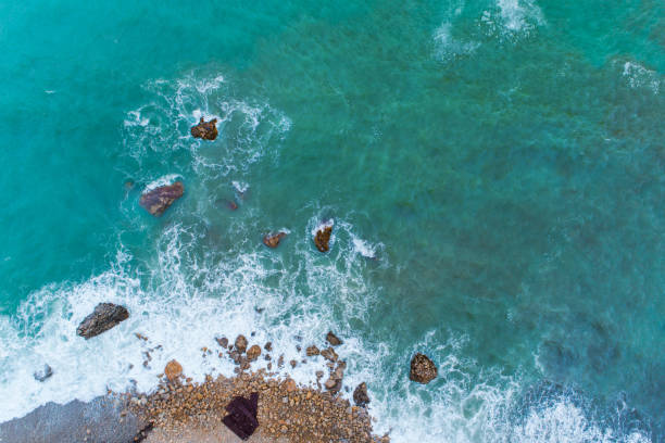 istock Flight over the turquoise waves that beat the rocks in Montenegro 870333084