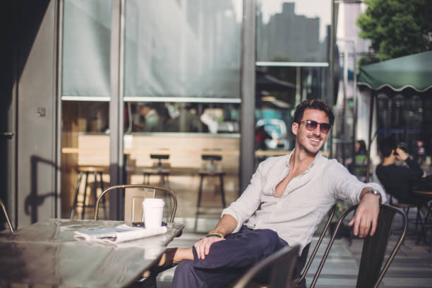 istock Young man sitting in coffee shop 870335930