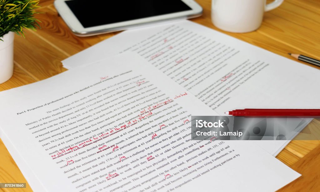 working hand hand working on paper for proofreading Proofreading Stock Photo