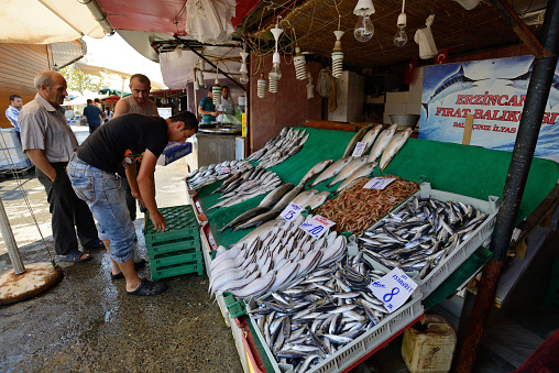 Istanbul, Turkey - August 8: Unknown man trades fish in a market near harbor, August 8, 2013 in Istanbul, Turkey. Istanbul is the world's fifth-most-popular tourist destination