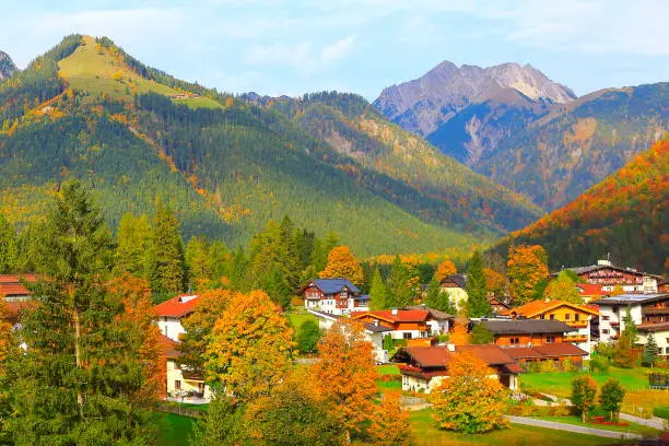 Above Pertisau alpine village, rustic  chalets and Alpine landscape in Austrian Tirol, near Karwendel mountain range and Bavarian alps in Germany - Majestic alpine landscape in gold colored autumn, dramatic Tyrol Snowcapped mountains panorama and Idyllic Tirol meadows, Austria