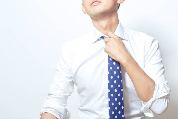 Japanese young man loosening his tie for a break
