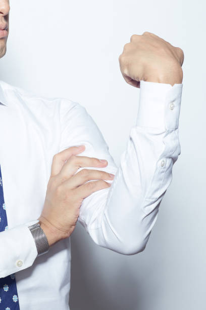 Young Japanese man feeling some pain in his arms