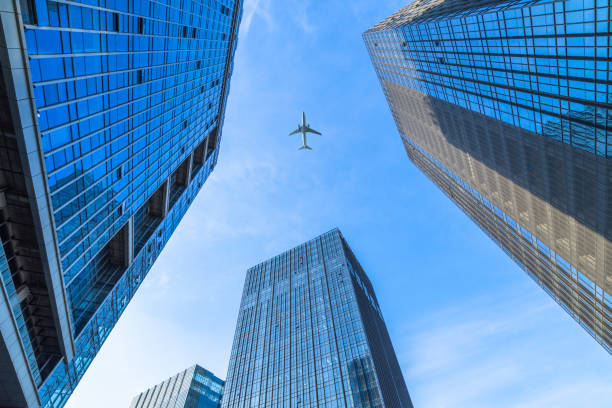 istock Plane flying over the skyscrapers 870364808