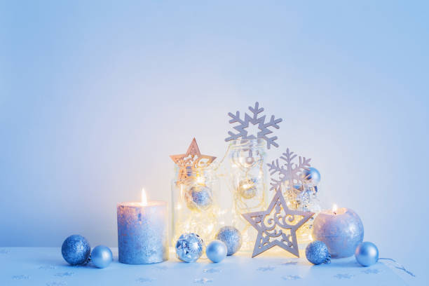 istock Christmas decoration with candles on background  white wall 870377596
