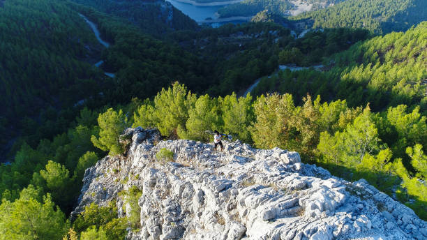 istock Mountain Biker walking on a rocky hillside 870380910